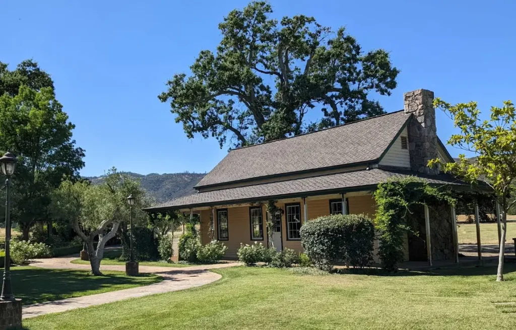 Small countryside house with front porch and well-kept lawn