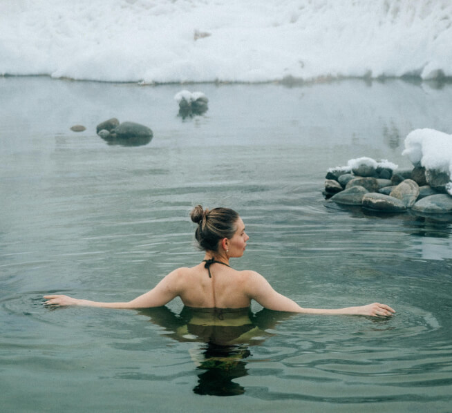 Outdoor spa pool with a woman during cold weather