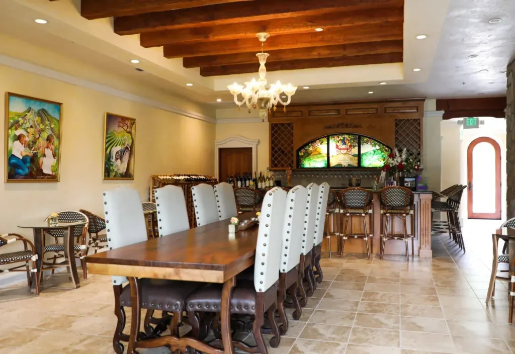 Indoor wine tasting room with long wood table and bar