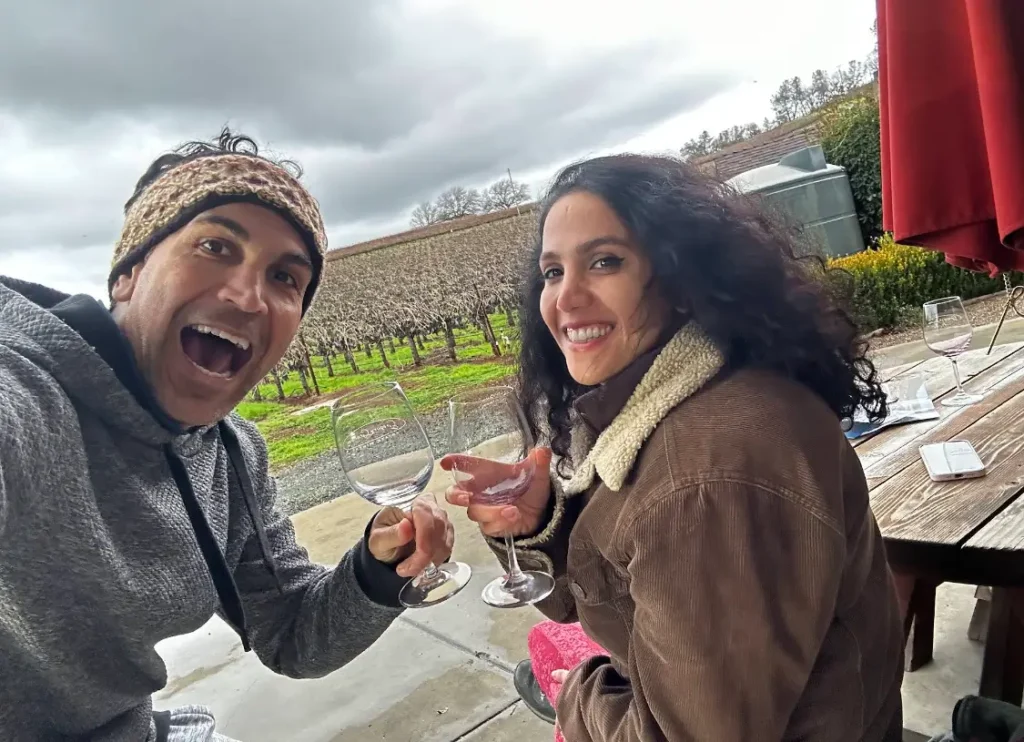 Couple wine tasting at vineyard patio