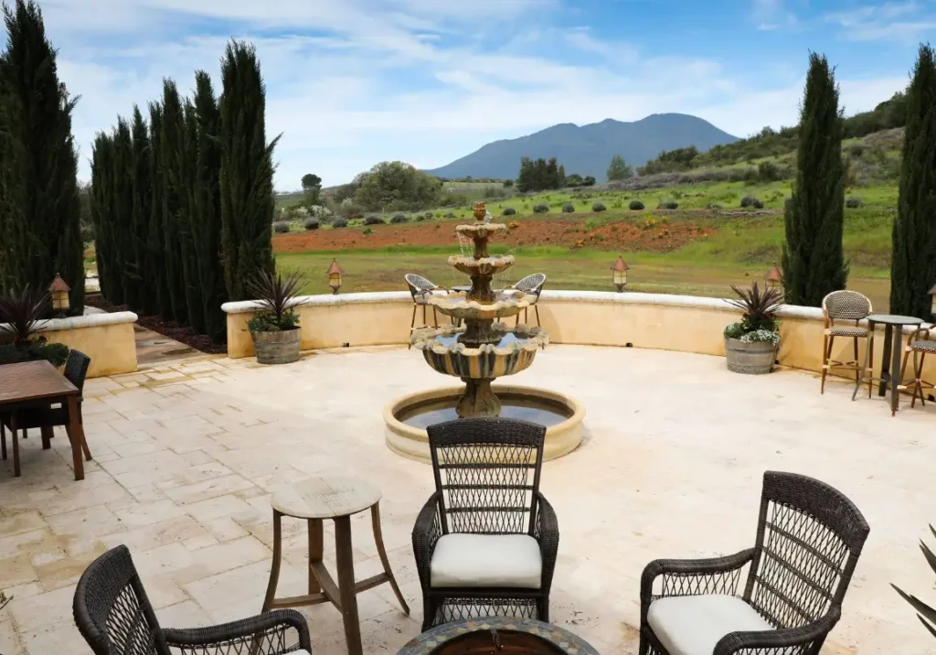 Courtyard with tiered fountain and mountain backdrop