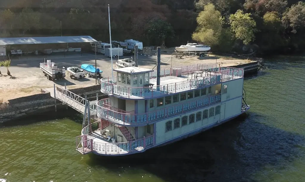 Vintage paddleboat docked at a lakeside marina
