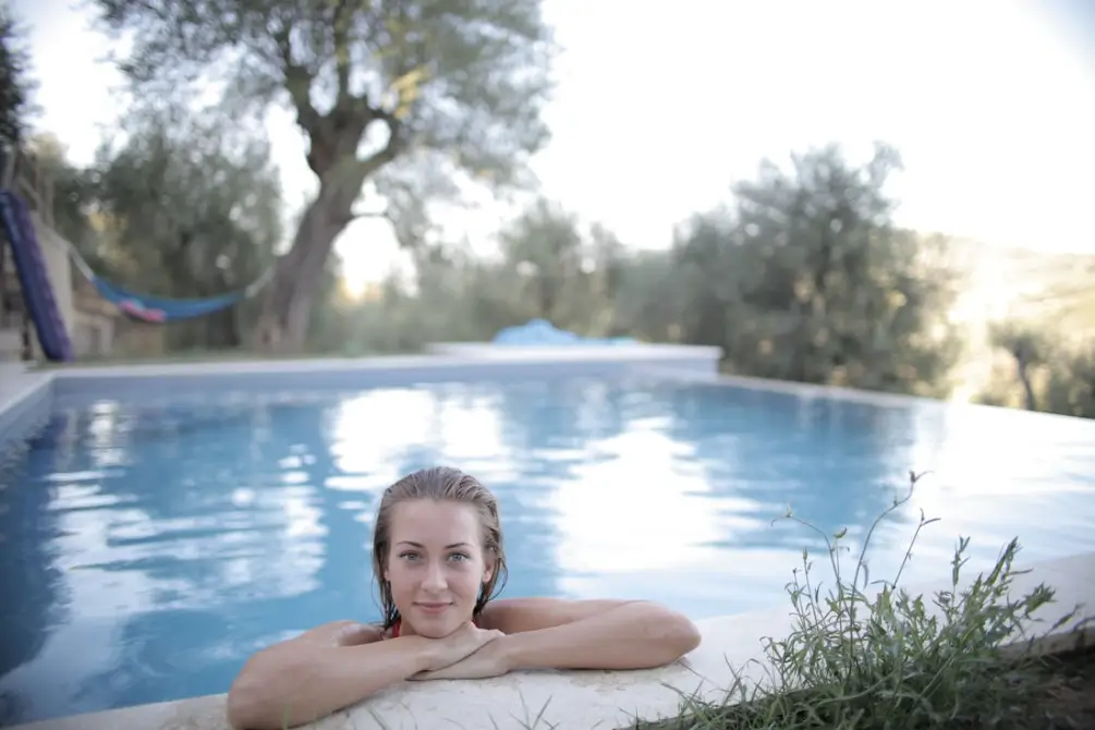 Woman Leaning On Poolside