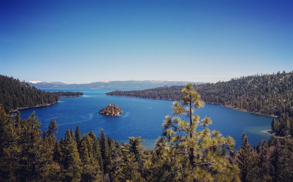 Scenic view of lake against clear blue sky